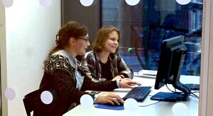 librarian instructing student in a group room