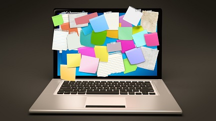 laptop full of post-its 